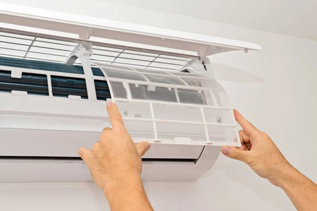 Hands opening split air conditioner front panel
