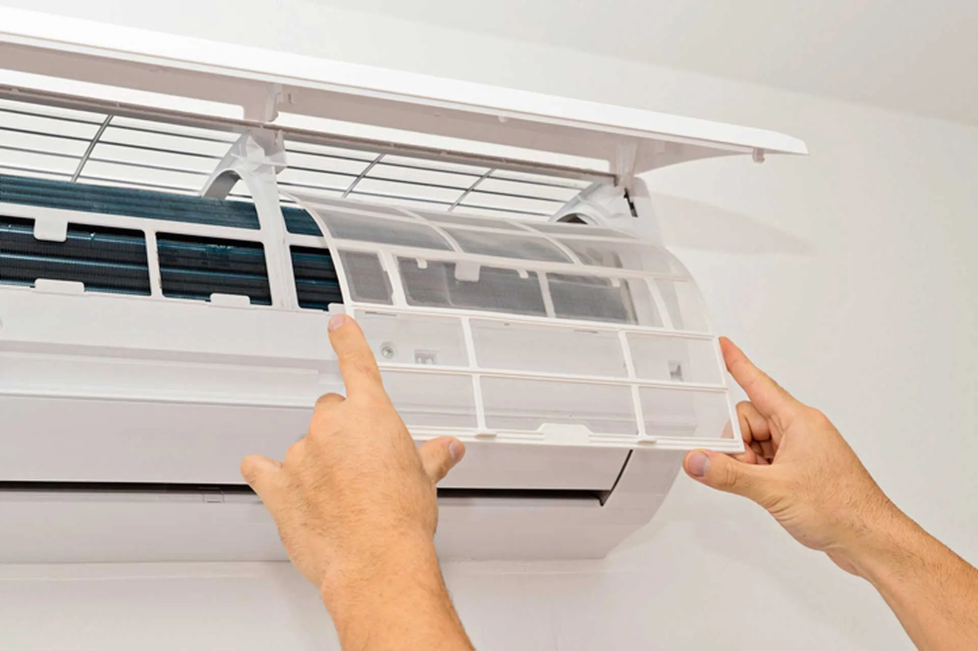 Hands opening split air conditioner front panel